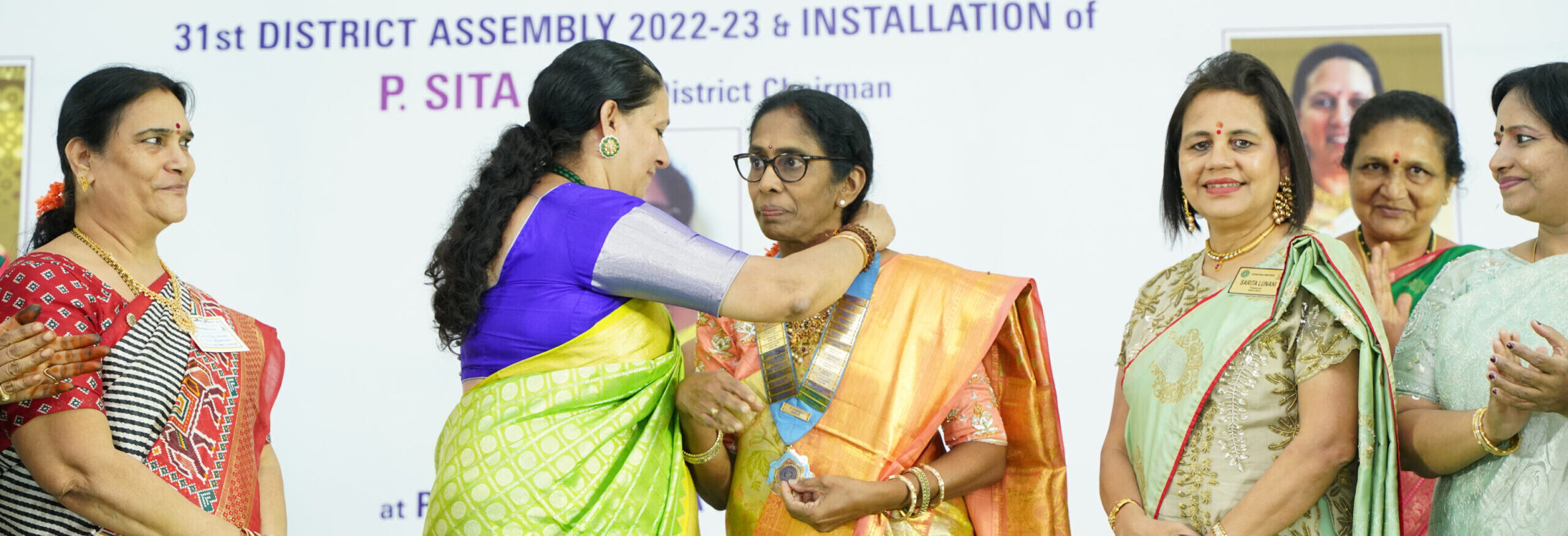 AC Member P. Yasoda handing over the baton to P. Sita Devi